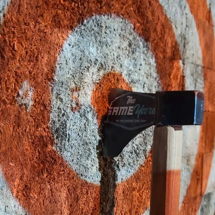 A Game Yard axe stuck in a throwing target